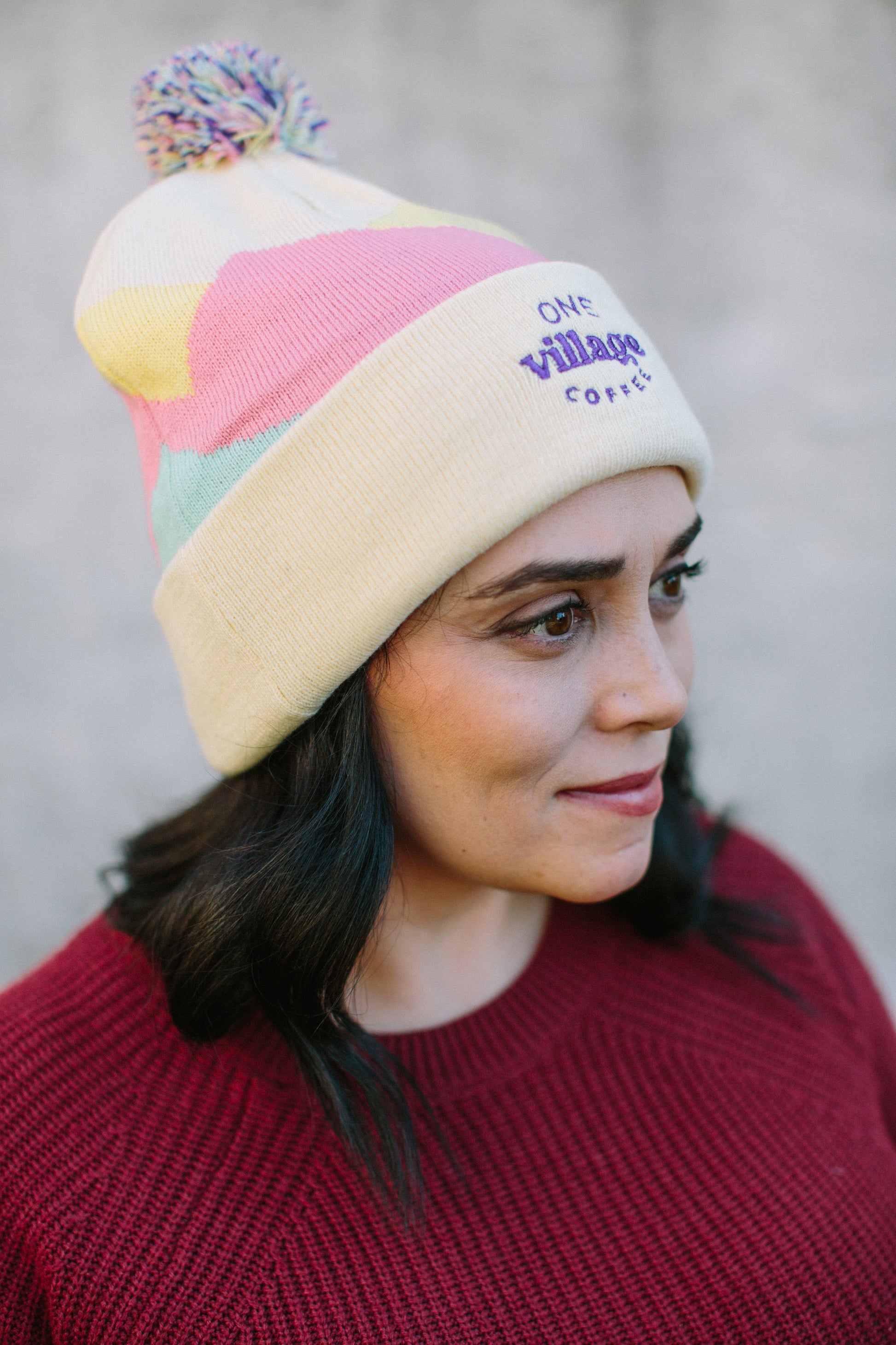 Image of a woman wearing a knit beanie, side profile. 