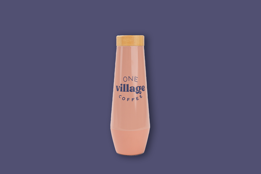 Image of pink tumbler with One Village Coffee label.